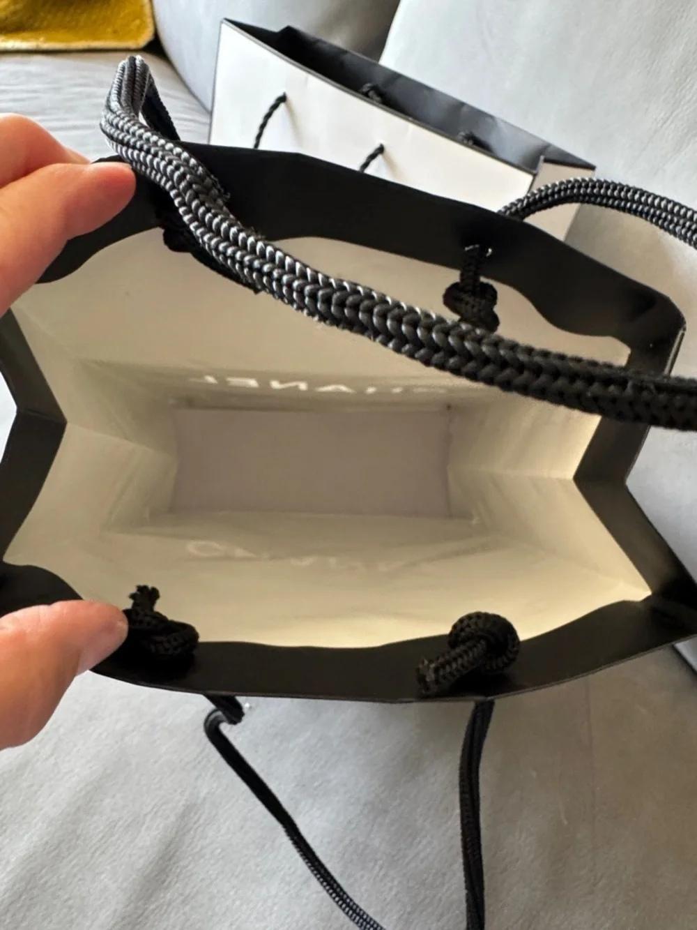 Chanel black logo matte paper gift bag + bonus eye makeup instruction booklet.